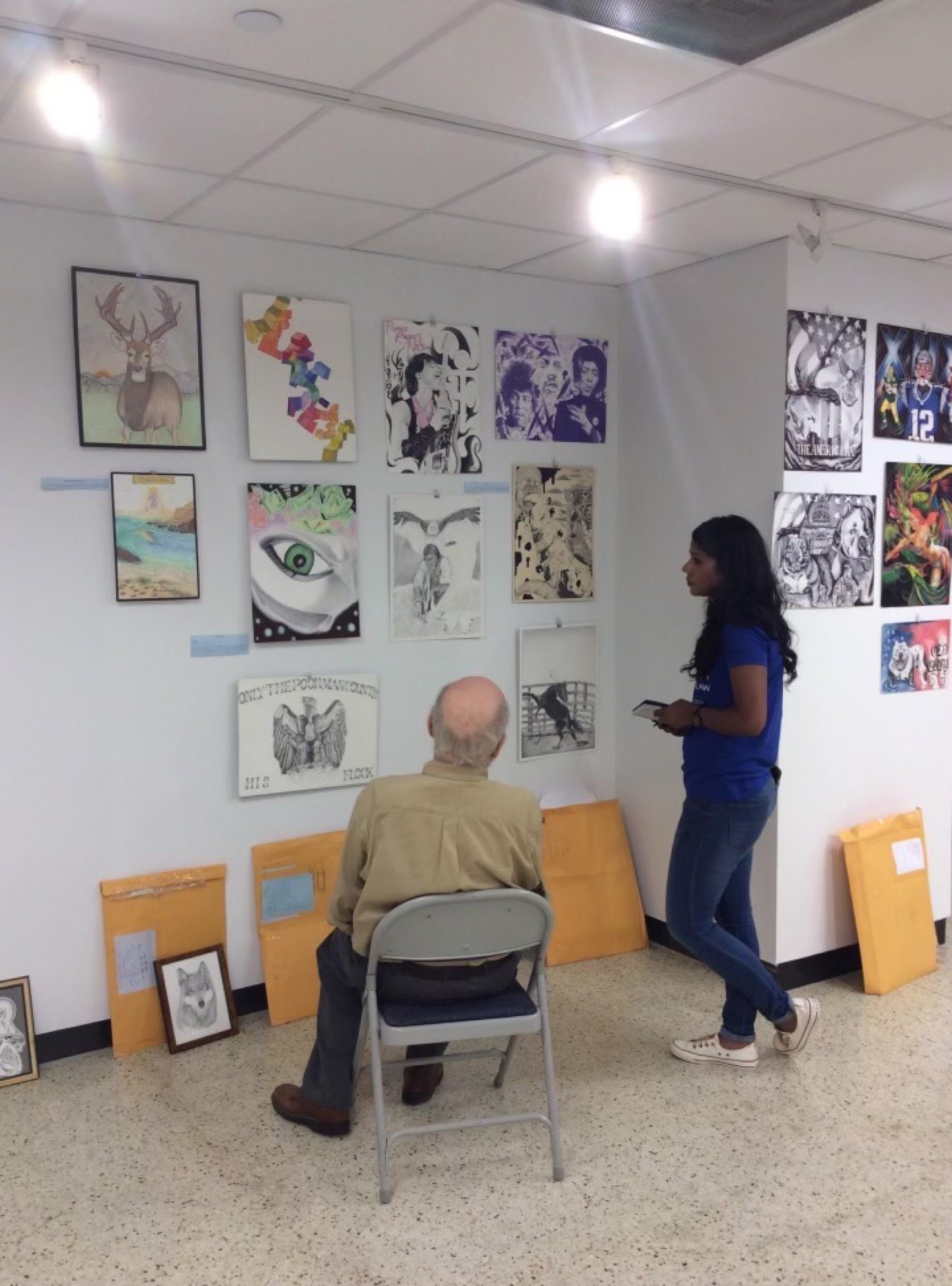 Murray Smither curating and hanging the gallery show for Daniel and the family.